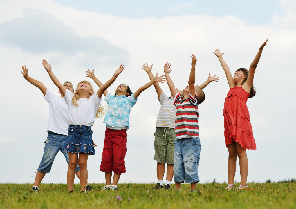 Kinder lächeln und schauen zum Himmel